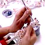 Sophie the Giraffe being hand painted
